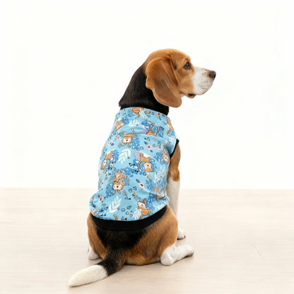 Dog wearing a blue shirt with animal patterns on a white background